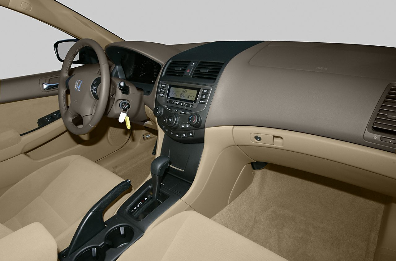 Beige interior with dashboard, steering wheel, and automatic gear shift.