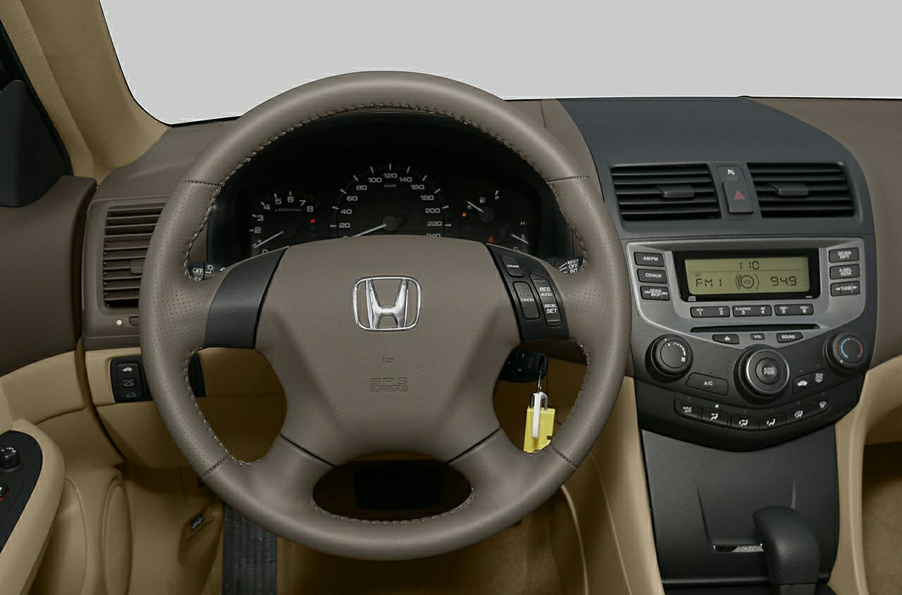 Steering wheel with control buttons and classic dashboard with instrument cluster