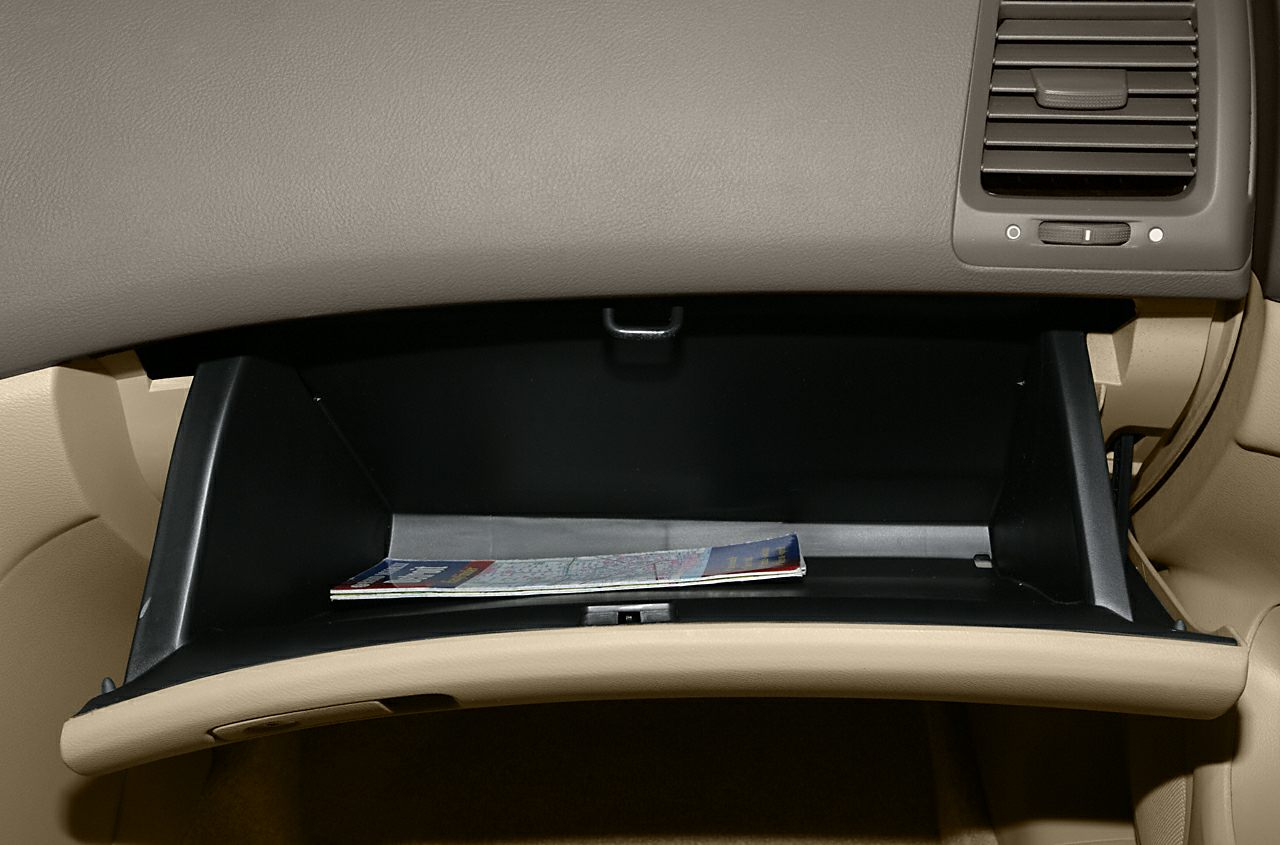 Open glove compartment with folded documents inside