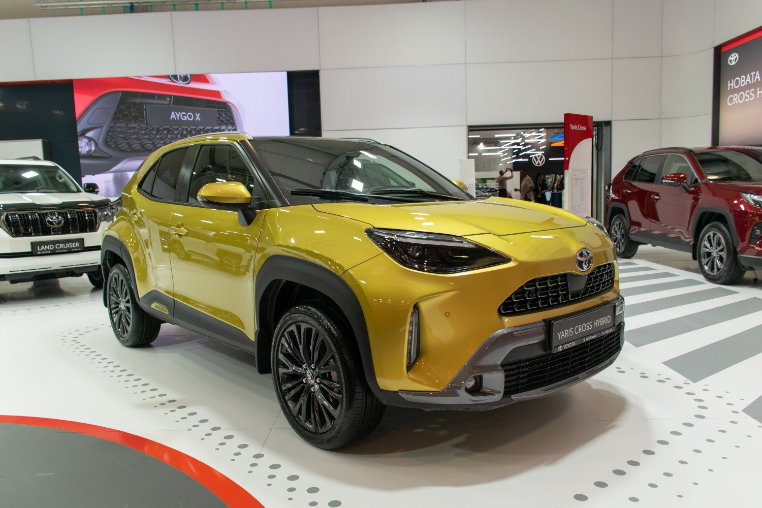 Compact hybrid SUV with yellow body and black alloy wheels