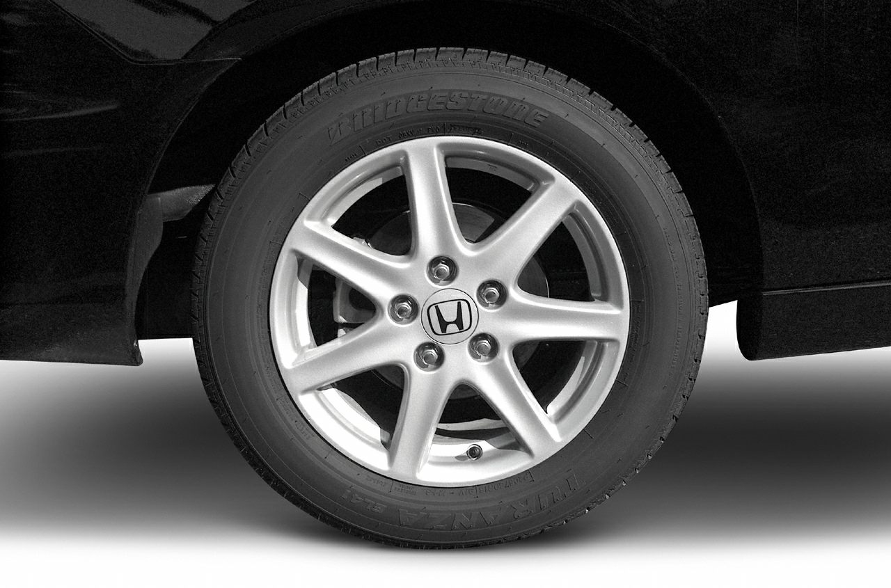 Close-up of alloy wheel and tire with seven-spoke rim design