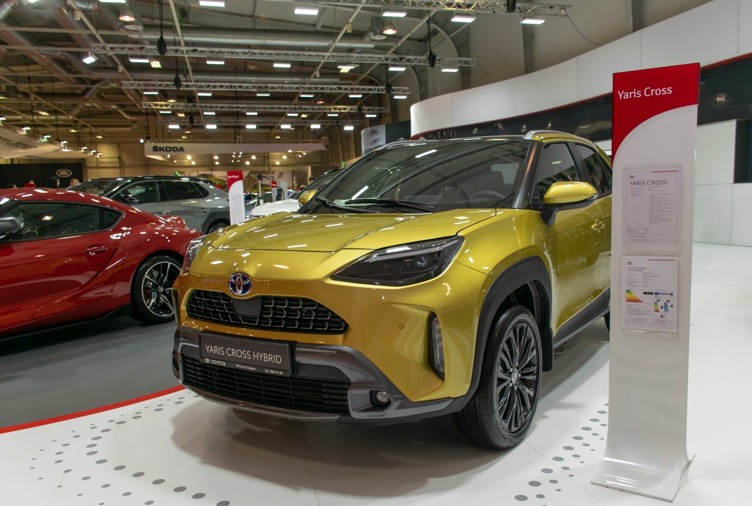 Front view of yellow hybrid SUV with modern headlights and grille