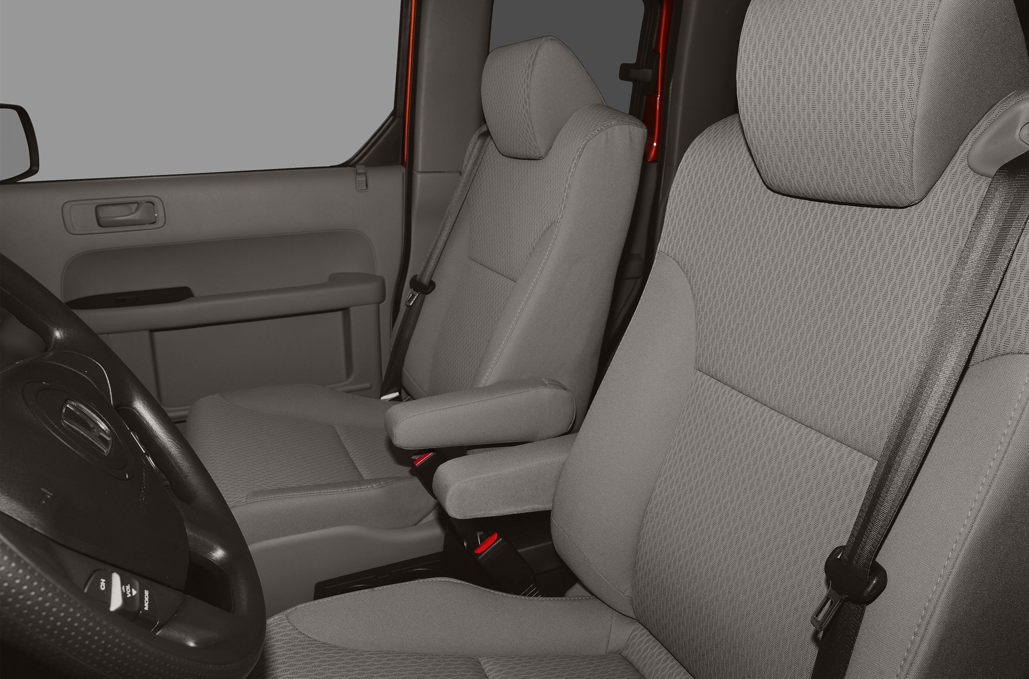 Front seats with fabric upholstery and armrests in car interior