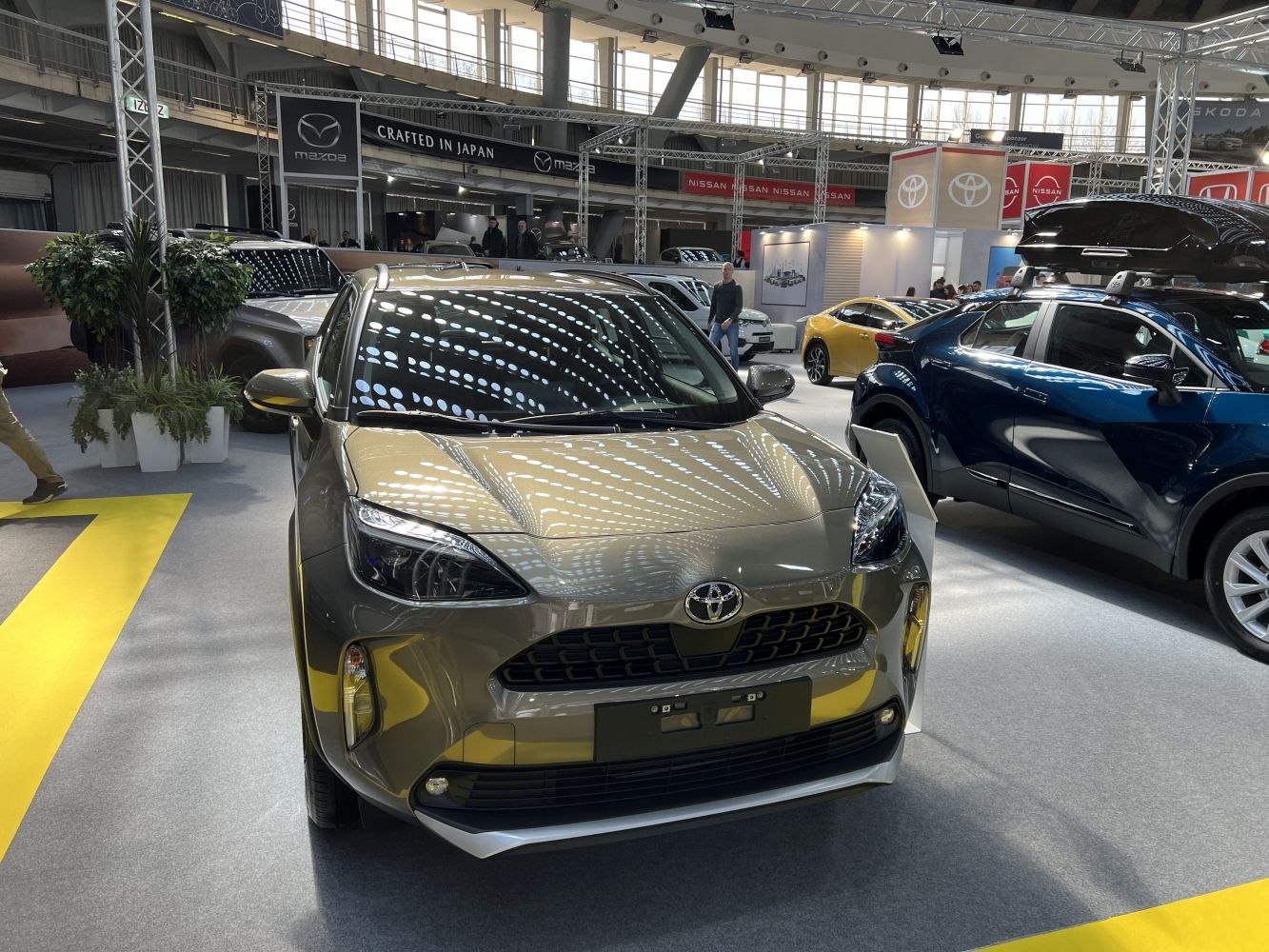 Front grille and headlights of a compact SUV in showroom