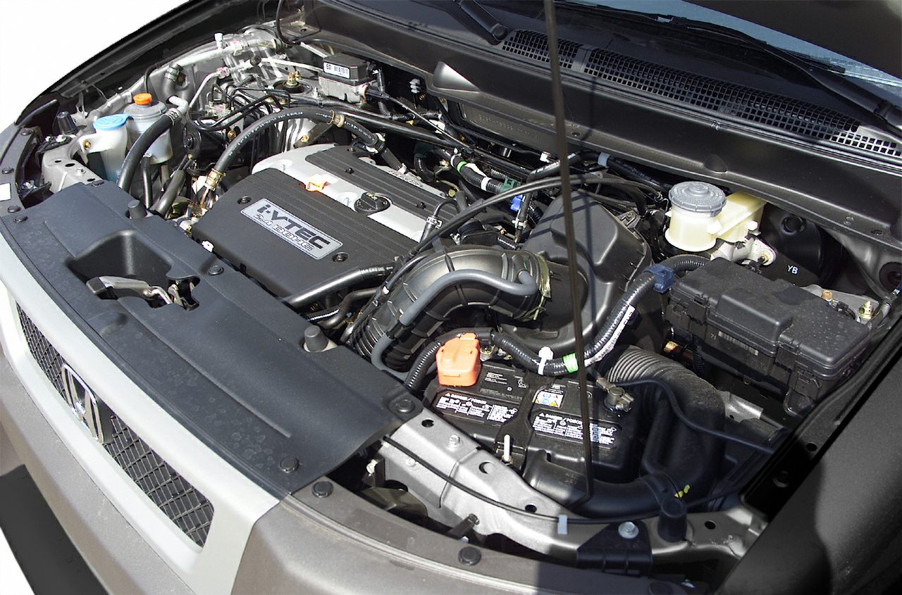 i-VTEC 2.4L engine bay with hoses and battery.