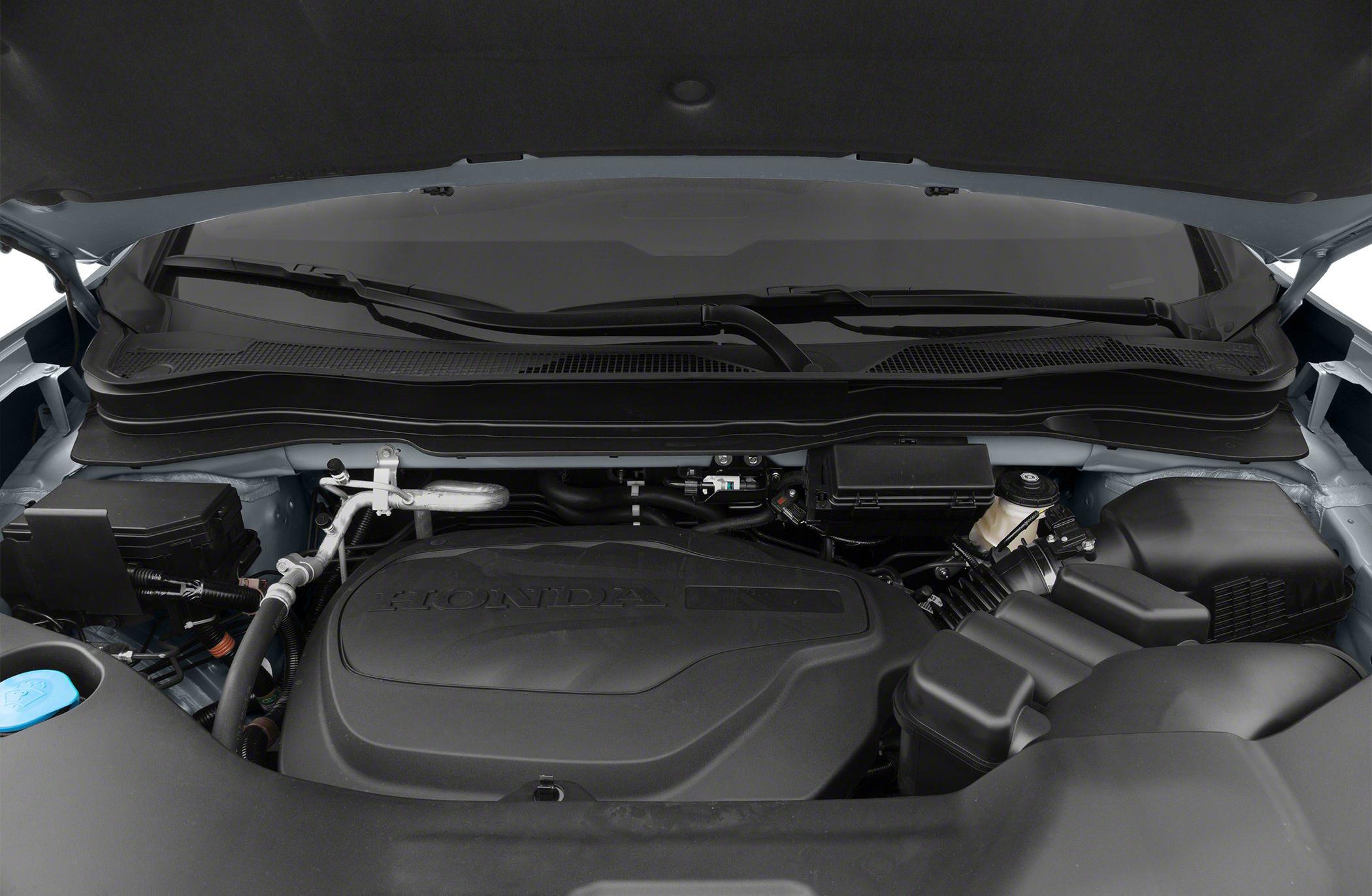 Engine bay featuring modern powertrain components under hood.
