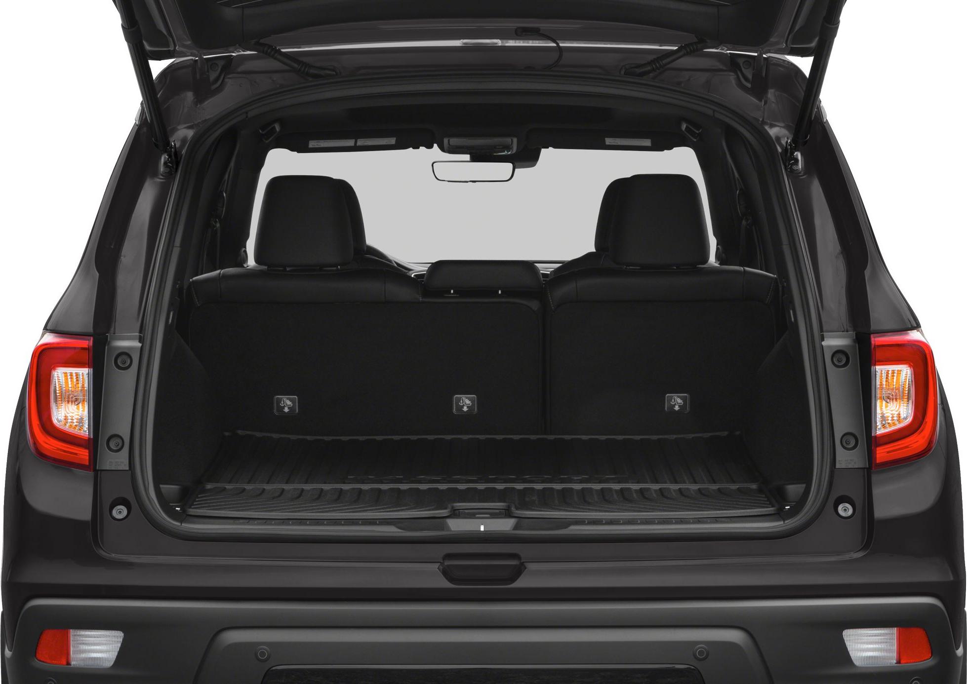 Open rear cargo area of a spacious SUV with visible rear seats and hatchback door.