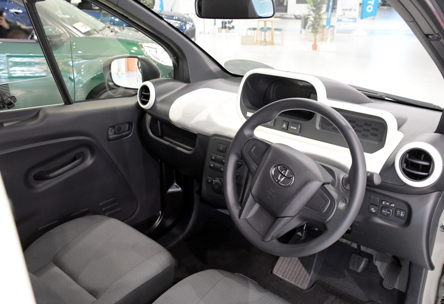 Dashboard and steering wheel view with control panel and seats