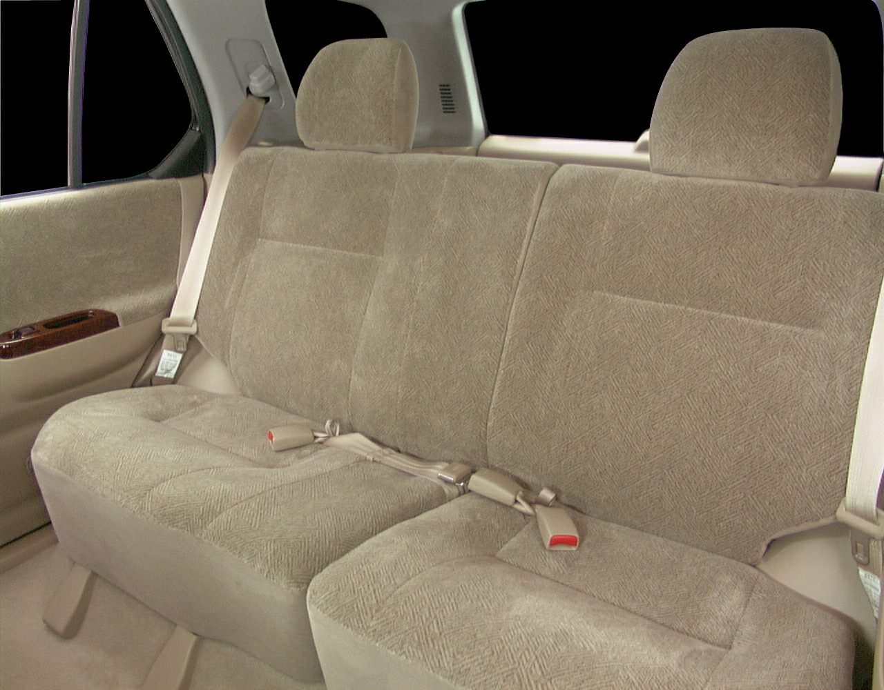 Rear bench seat with beige fabric upholstery and seatbelts