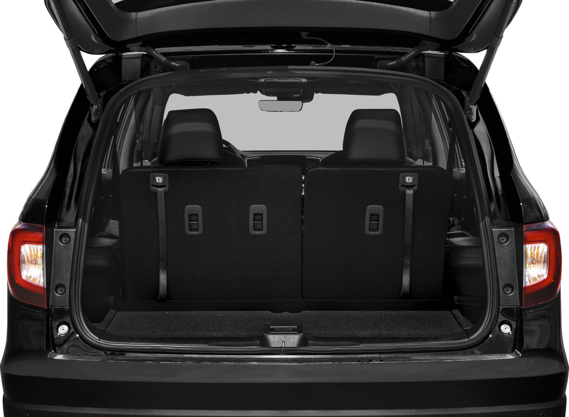 Open rear cargo area with upright rear seats in an SUV.
