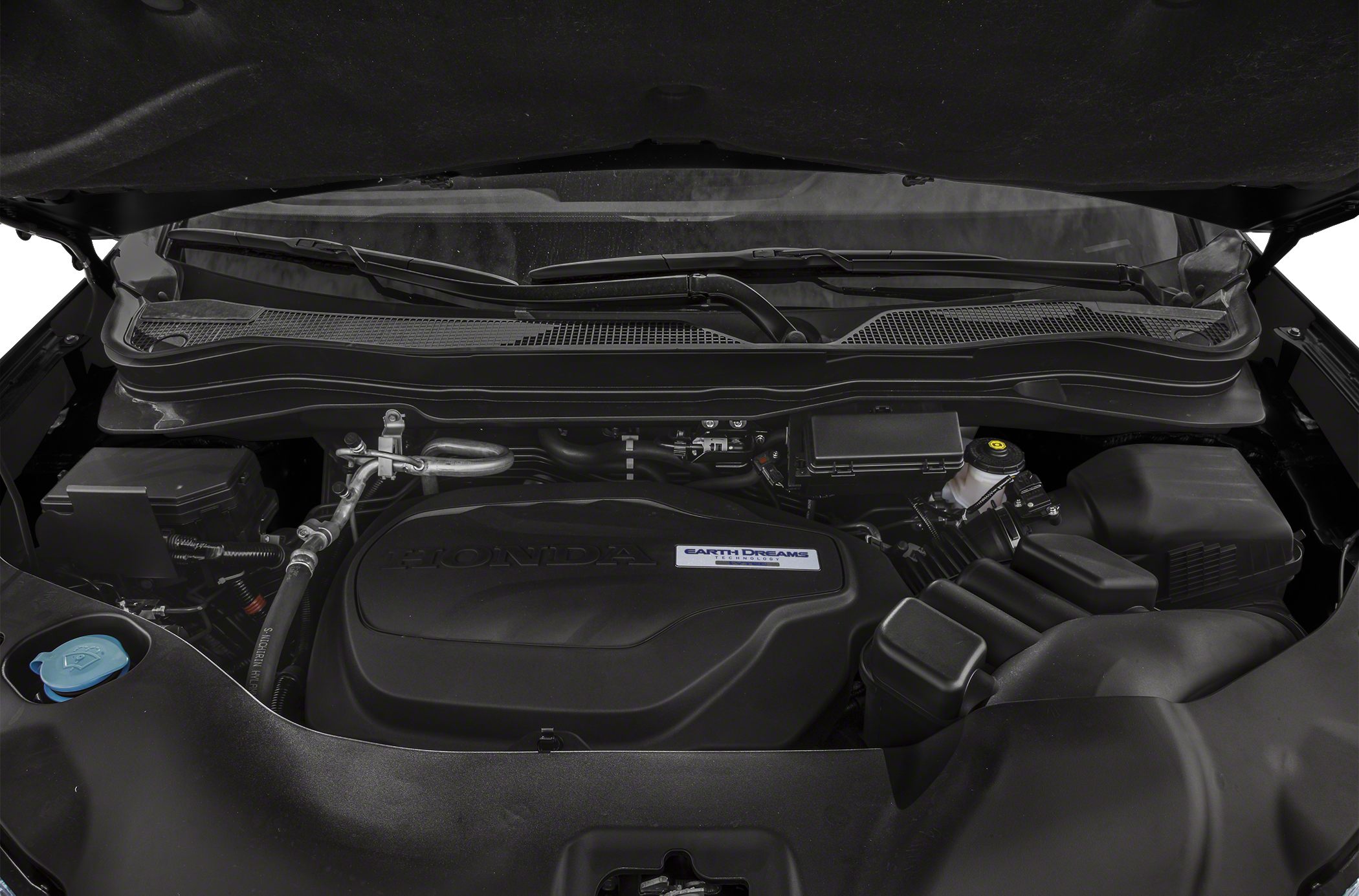 Close-up of engine cover and components with Earth Dreams Technology branding