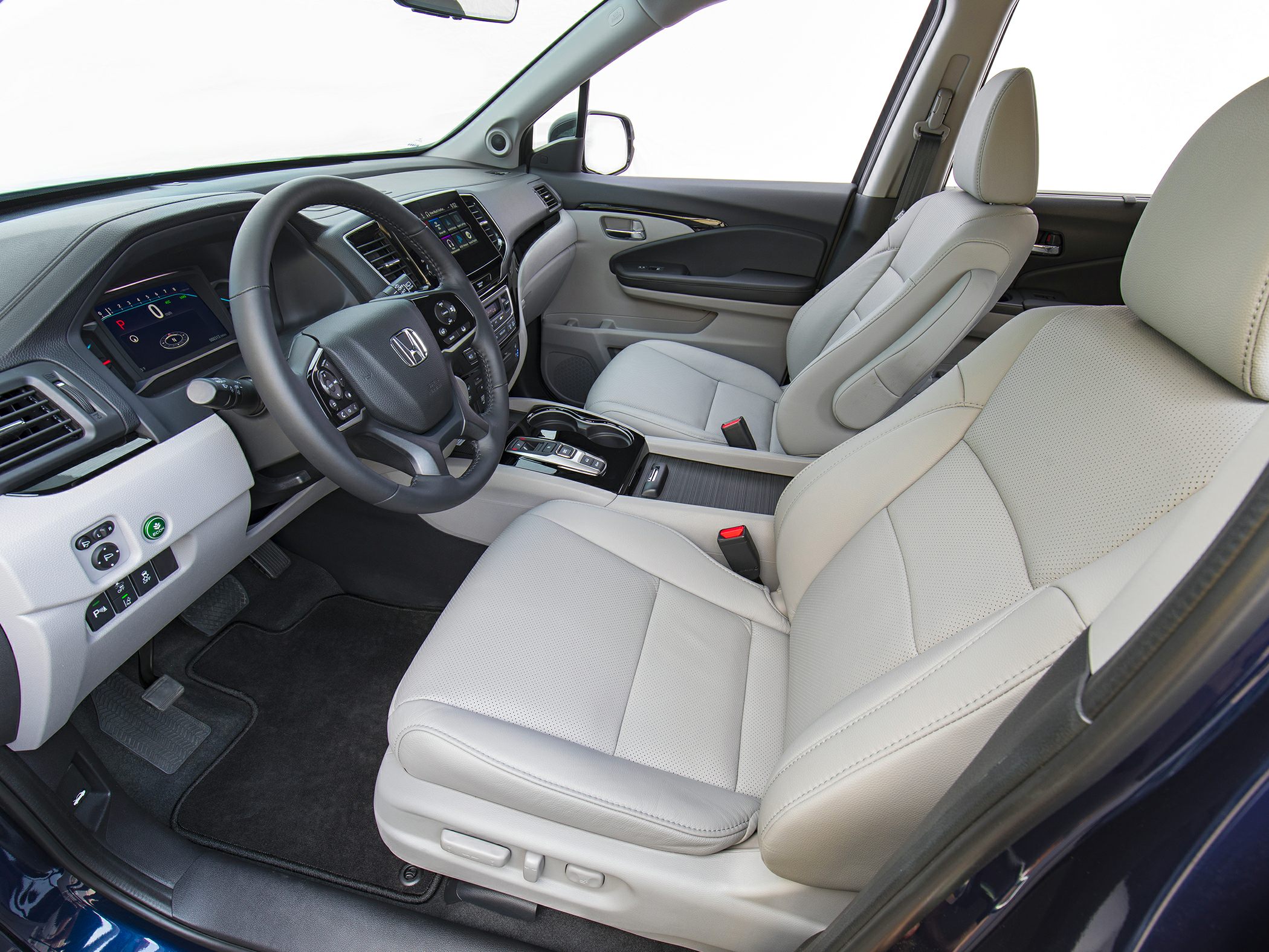Leather front seats and modern dashboard with infotainment screen