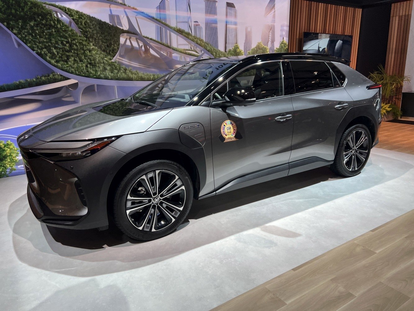 Side profile of a gray electric SUV with award badge and sleek alloy wheels