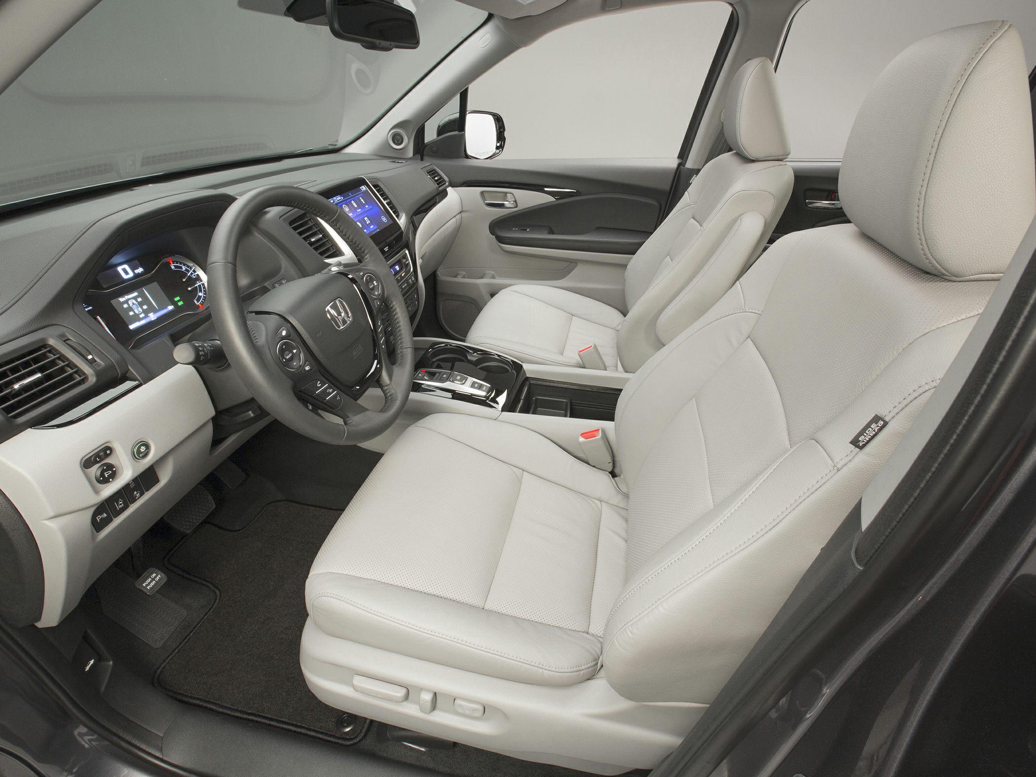 Front interior with leather seats, dashboard, digital gauges, and steering wheel controls
