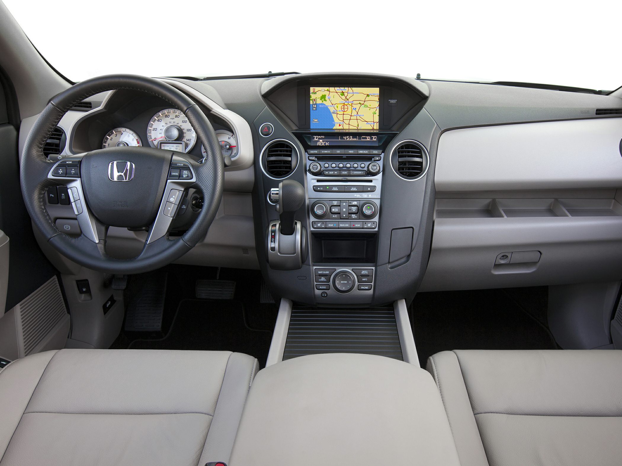 Dashboard with navigation screen, steering wheel controls, and center console.