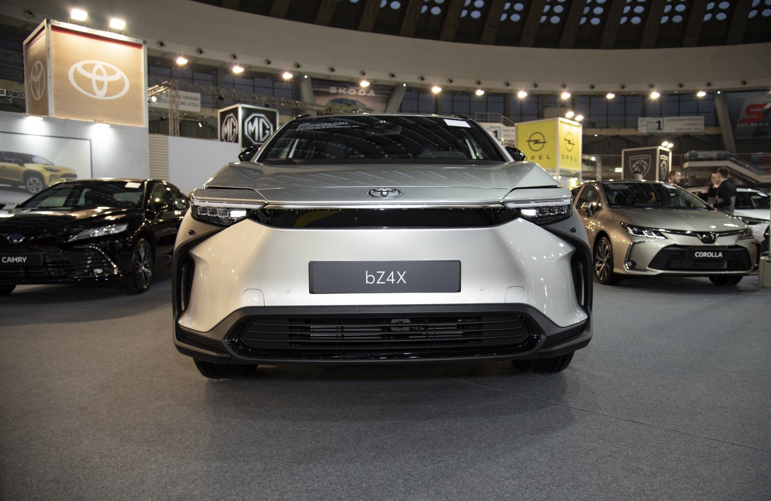 Front view of a modern electric SUV with sleek LED headlights and aerodynamic design