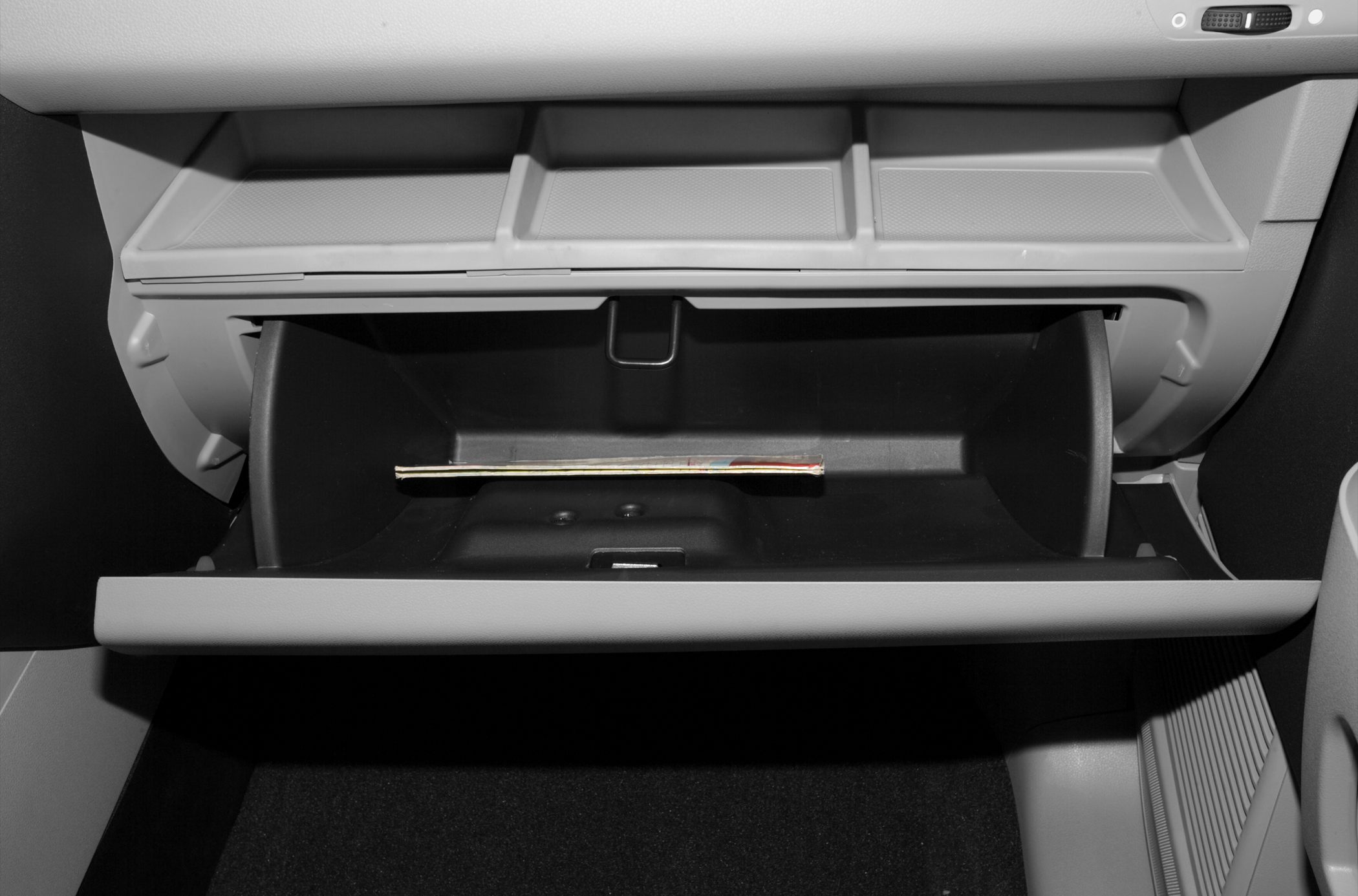 Open glove compartment with upper storage slots