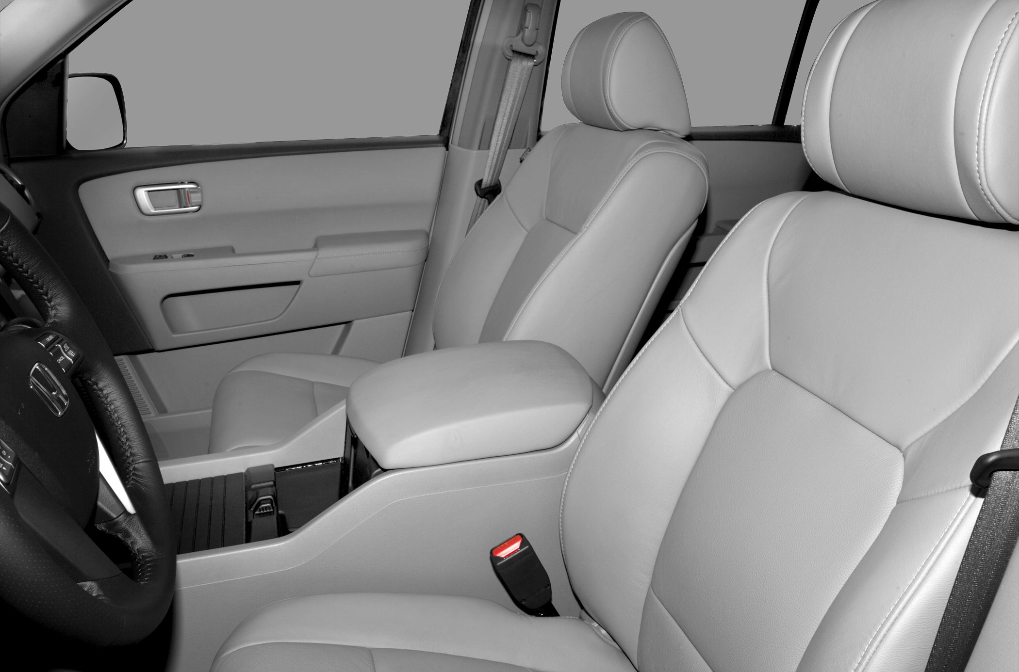 Leather front seats with armrest and visible seatbelt.