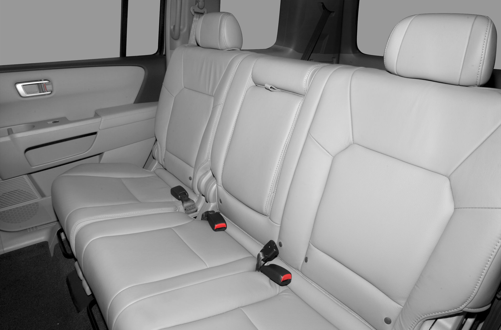 Leather upholstered rear seat with seatbelt buckles