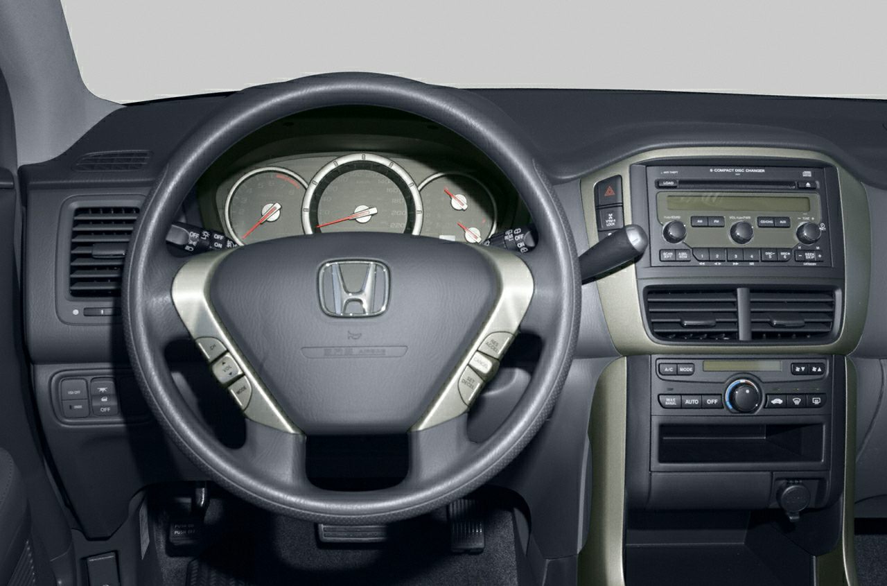 Steering wheel with controls, instrument cluster, and center console with audio and climate controls