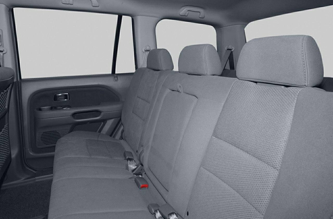 Fabric rear seats with headrests and seat belts inside an SUV