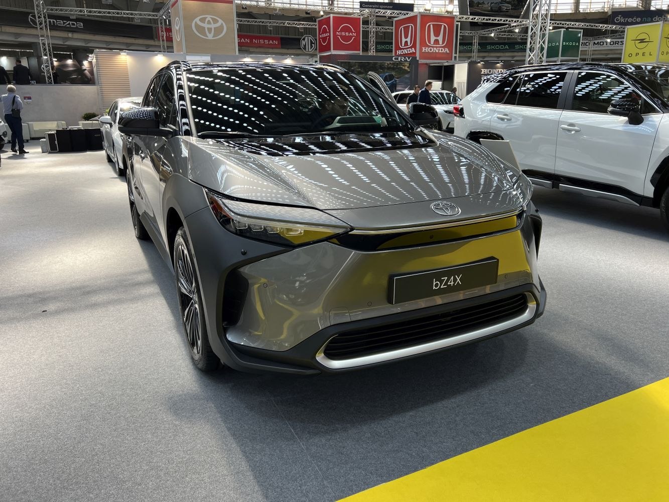 Modern electric SUV front with sleek LED headlights and smooth contours