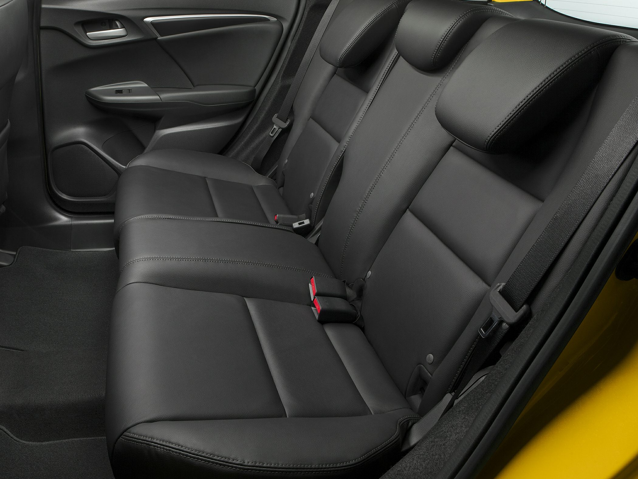 Black leather rear seat with stitched upholstery and integrated headrests