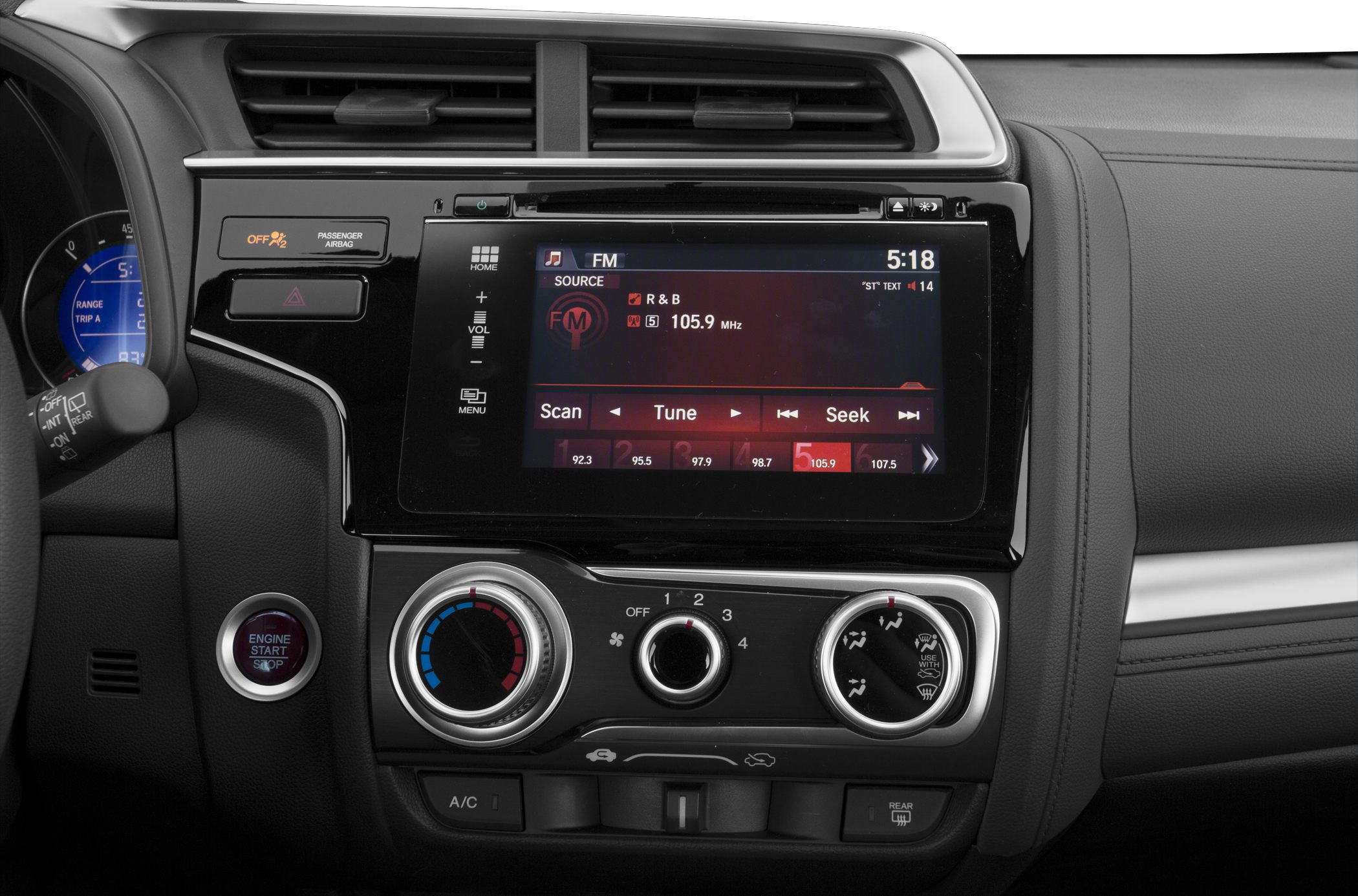 Touchscreen radio and manual climate control dials in car dashboard