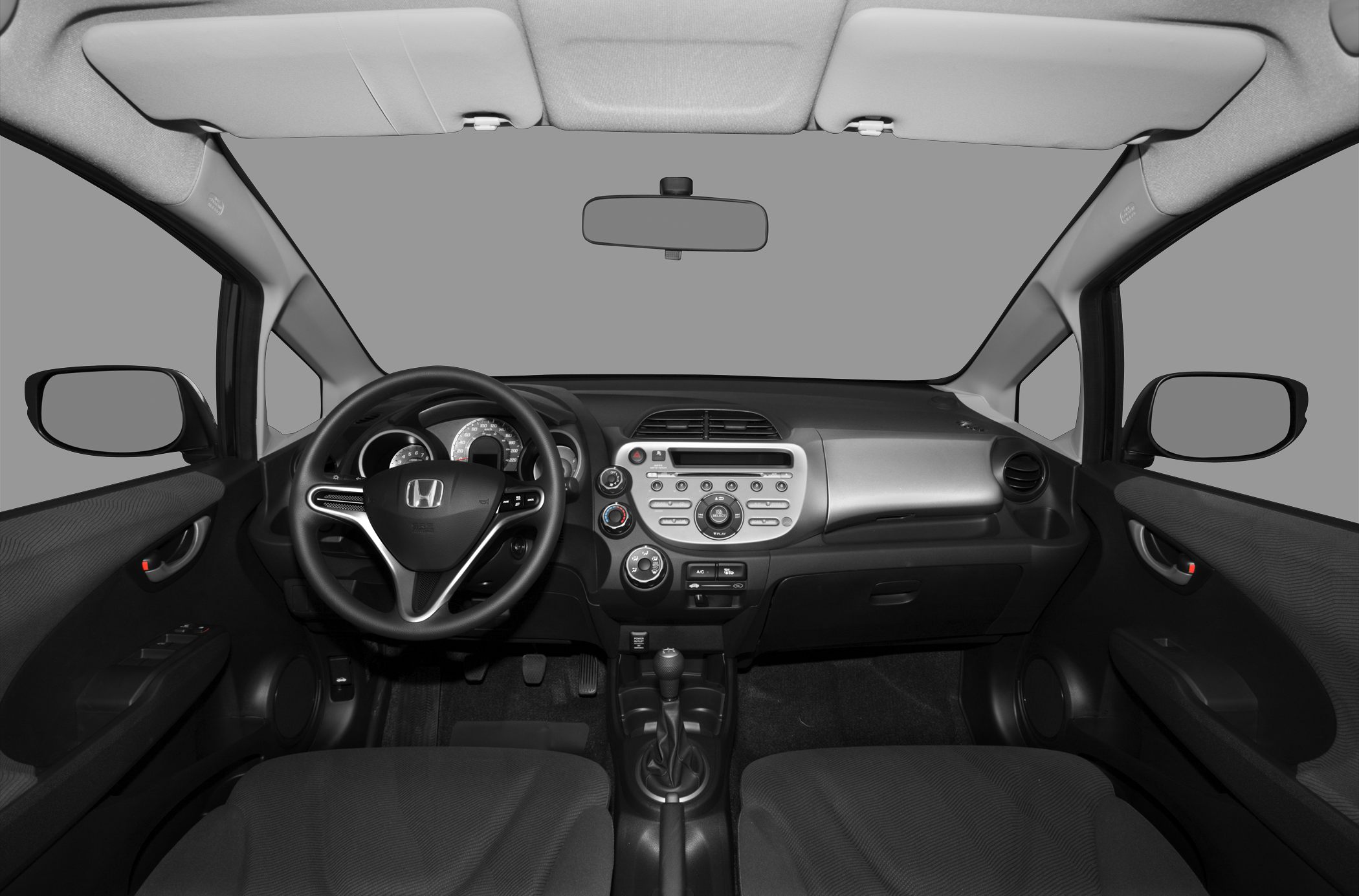 Dashboard and steering wheel inside a compact car cabin
