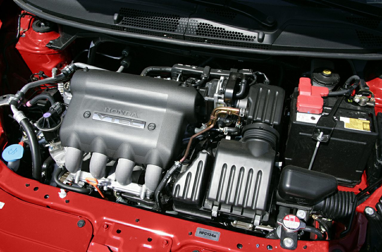 Close-up of VTEC engine bay with visible components and battery.