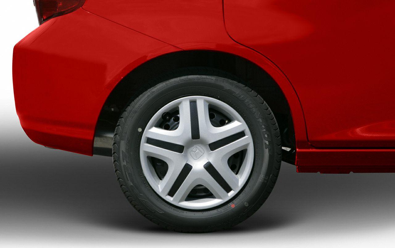 Close-up of rear wheel and red fender with unique rim design and Dunlop tire.