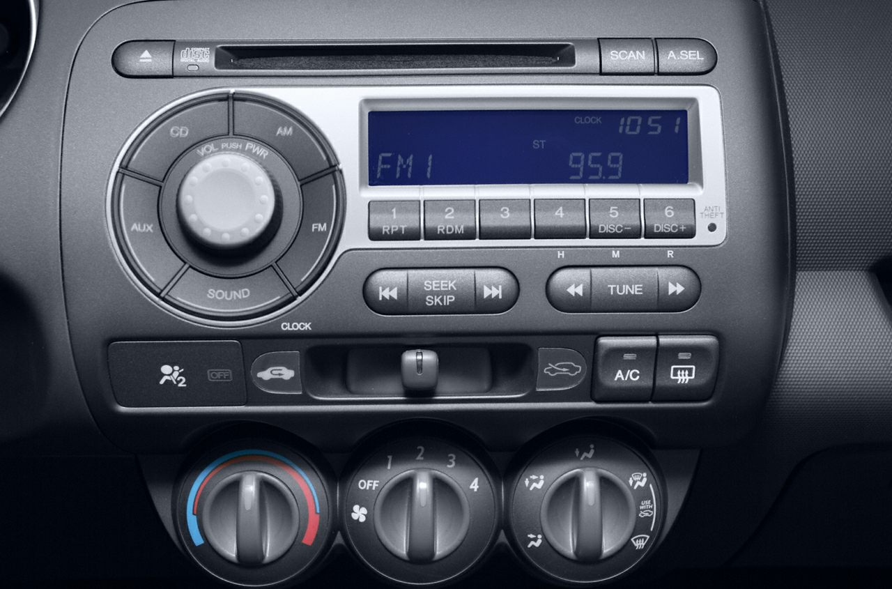 Car audio system and manual climate control dials.