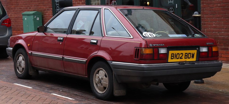 Rear and side view of a classic hatchback with vintage styling.