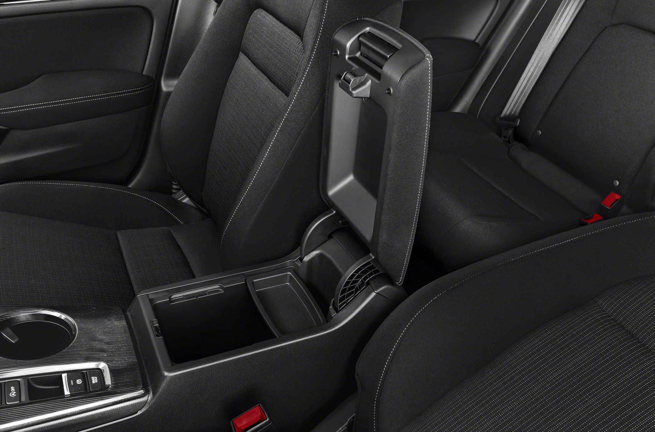 Interior center console with open storage compartment and armrest.