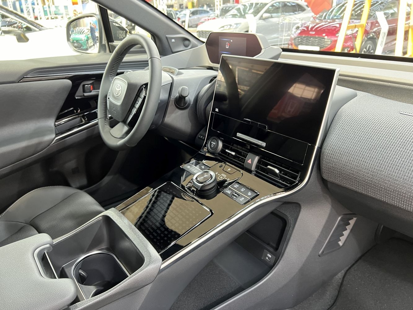Large touchscreen display and ergonomic control knob in a modern car interior