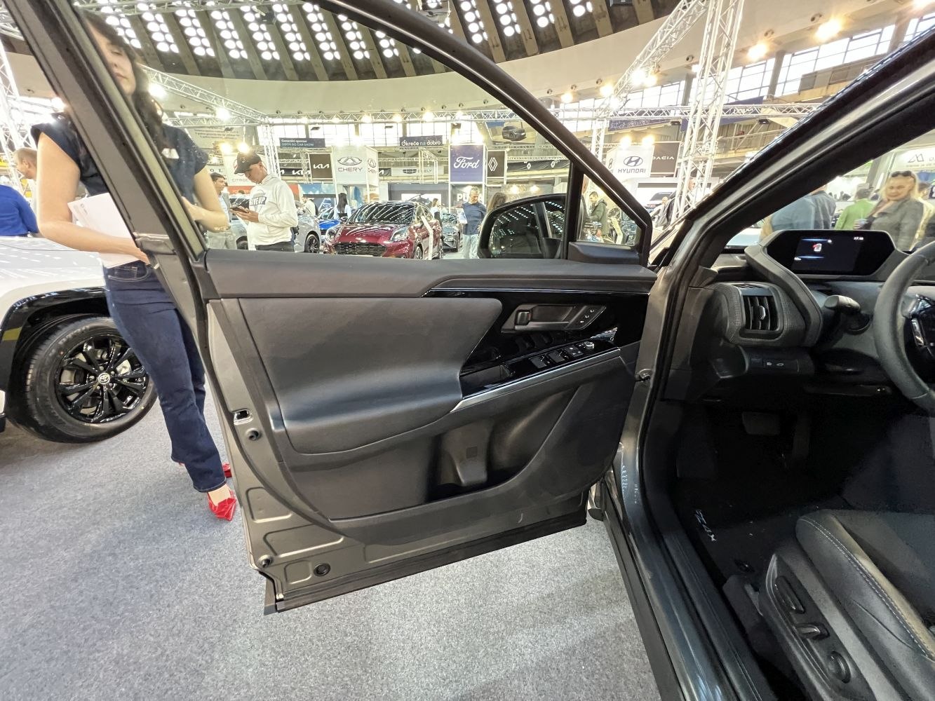 Driver side door panel with controls and seating area