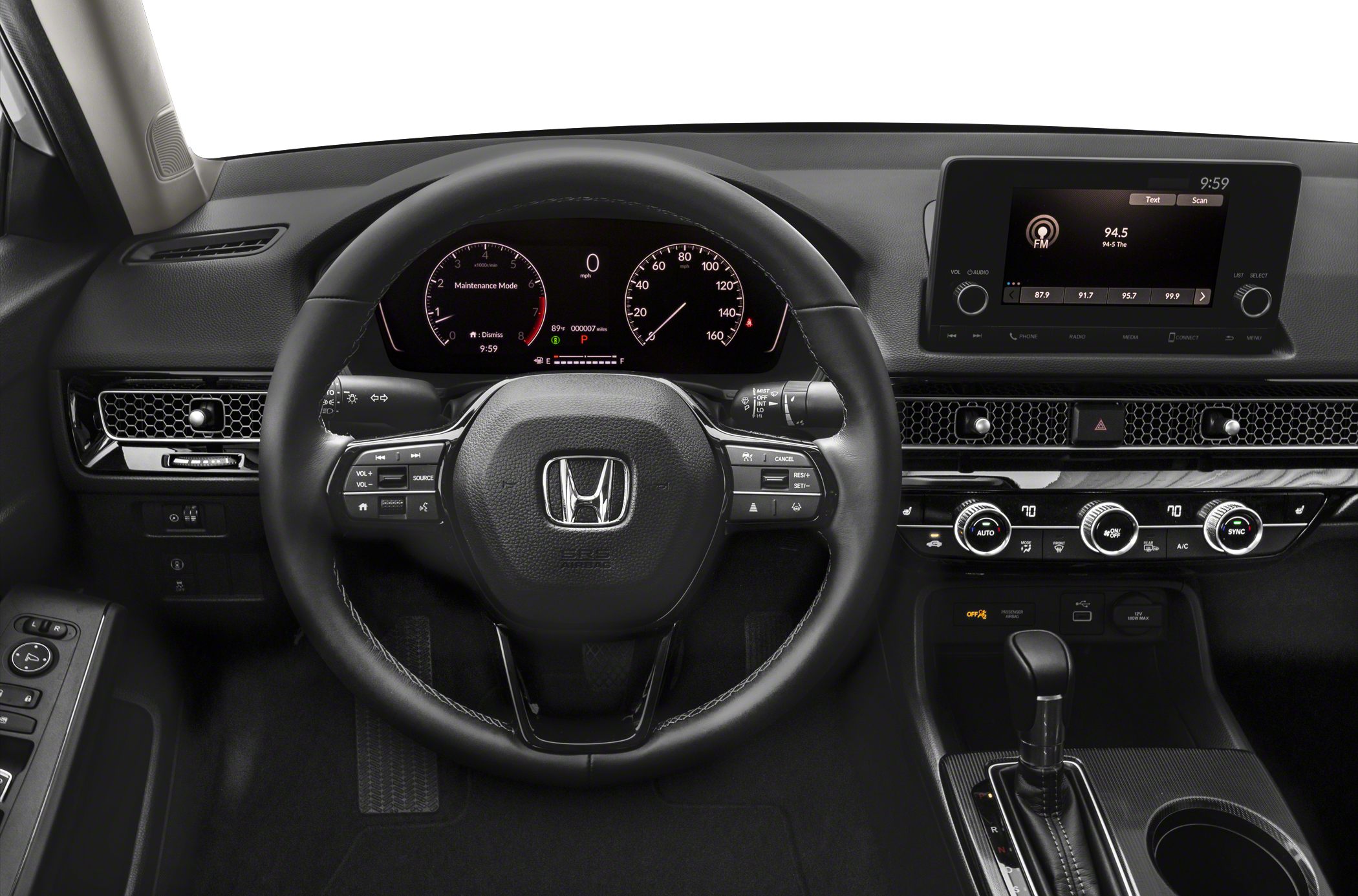 Steering wheel with controls and digital dashboard, infotainment screen and climate control knobs