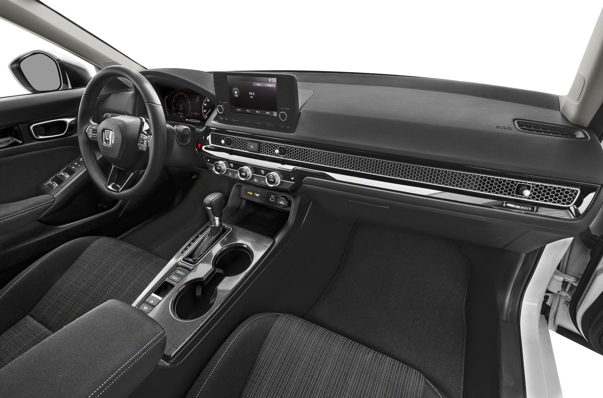 Car interior with digital display, climate controls, and gear shifter