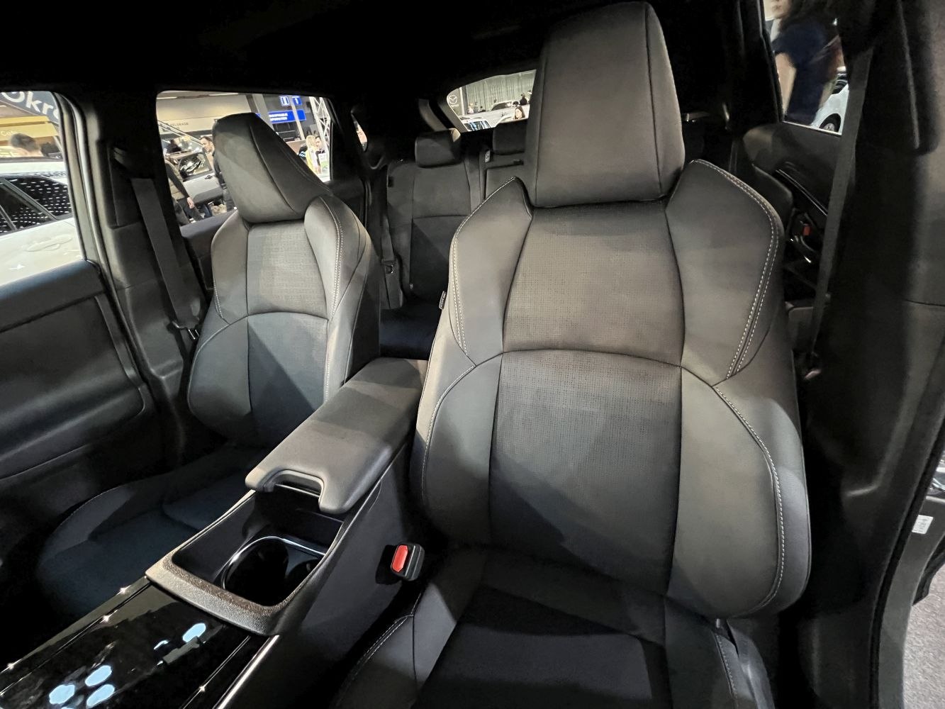 Front seats and center console with cupholder in modern vehicle interior
