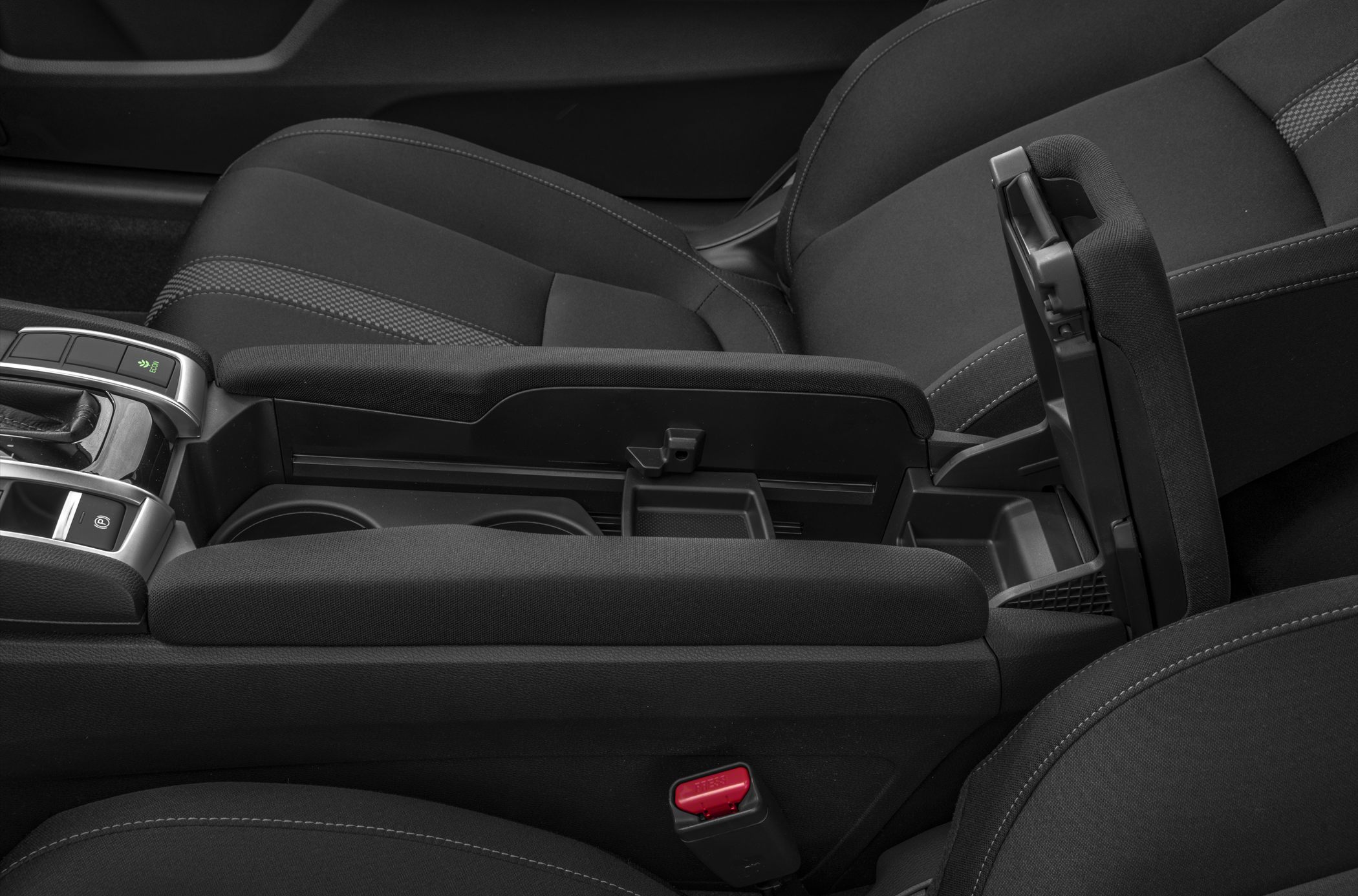 Center console with open armrest storage and cup holders