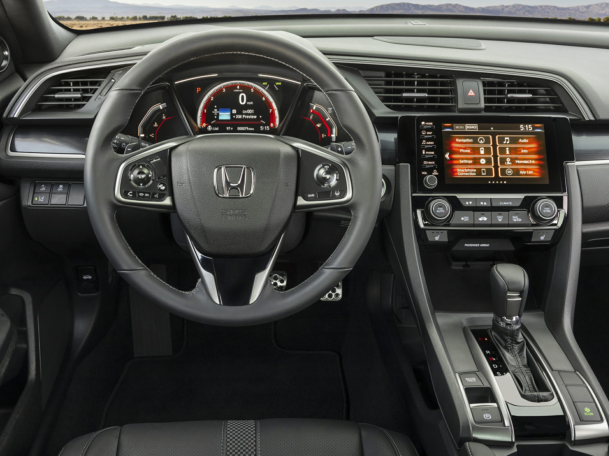 Steering wheel, digital instrument cluster, touchscreen infotainment, climate controls, gear shifter
