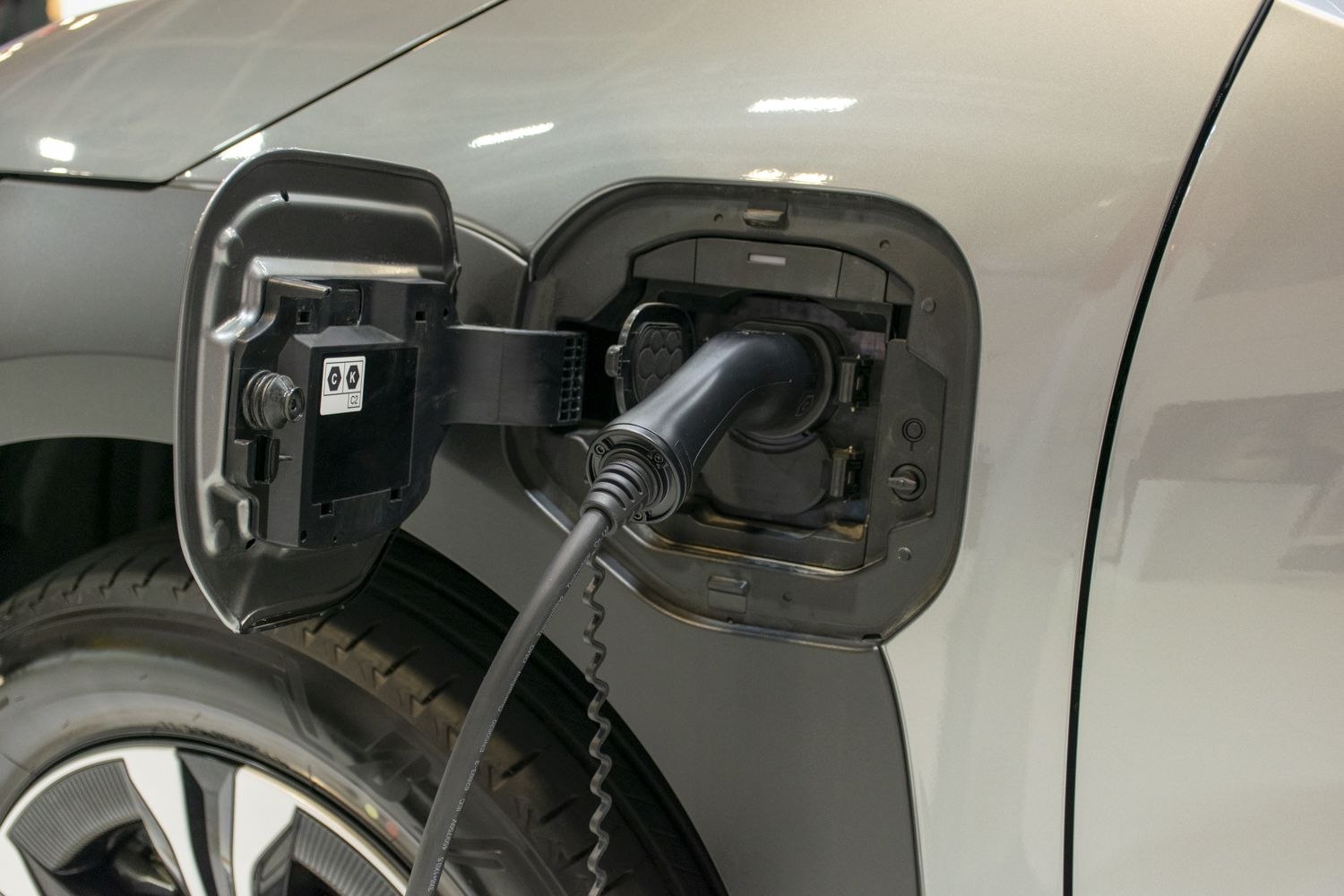 Close-up of electric vehicle charging port with connector plugged in
