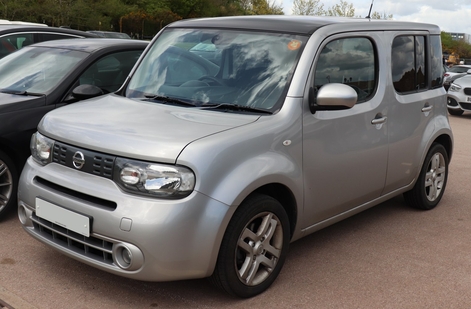 Silver boxy compact car with unique rounded edges and five-door design