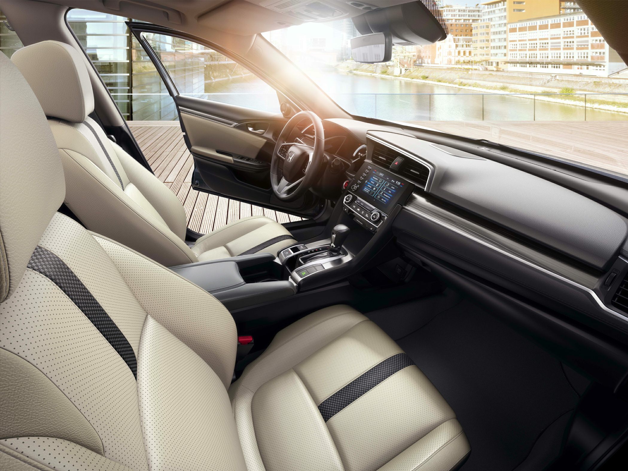 Beige perforated leather seats and modern dashboard design in car interior