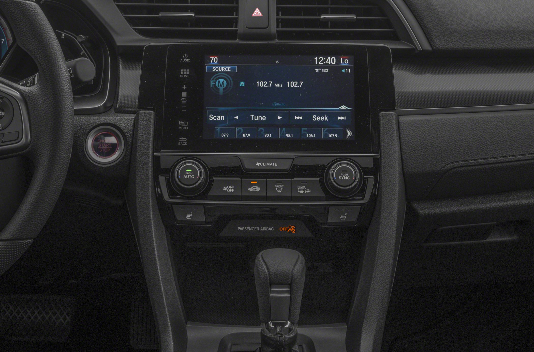 Touchscreen infotainment and dual-zone climate control center console.
