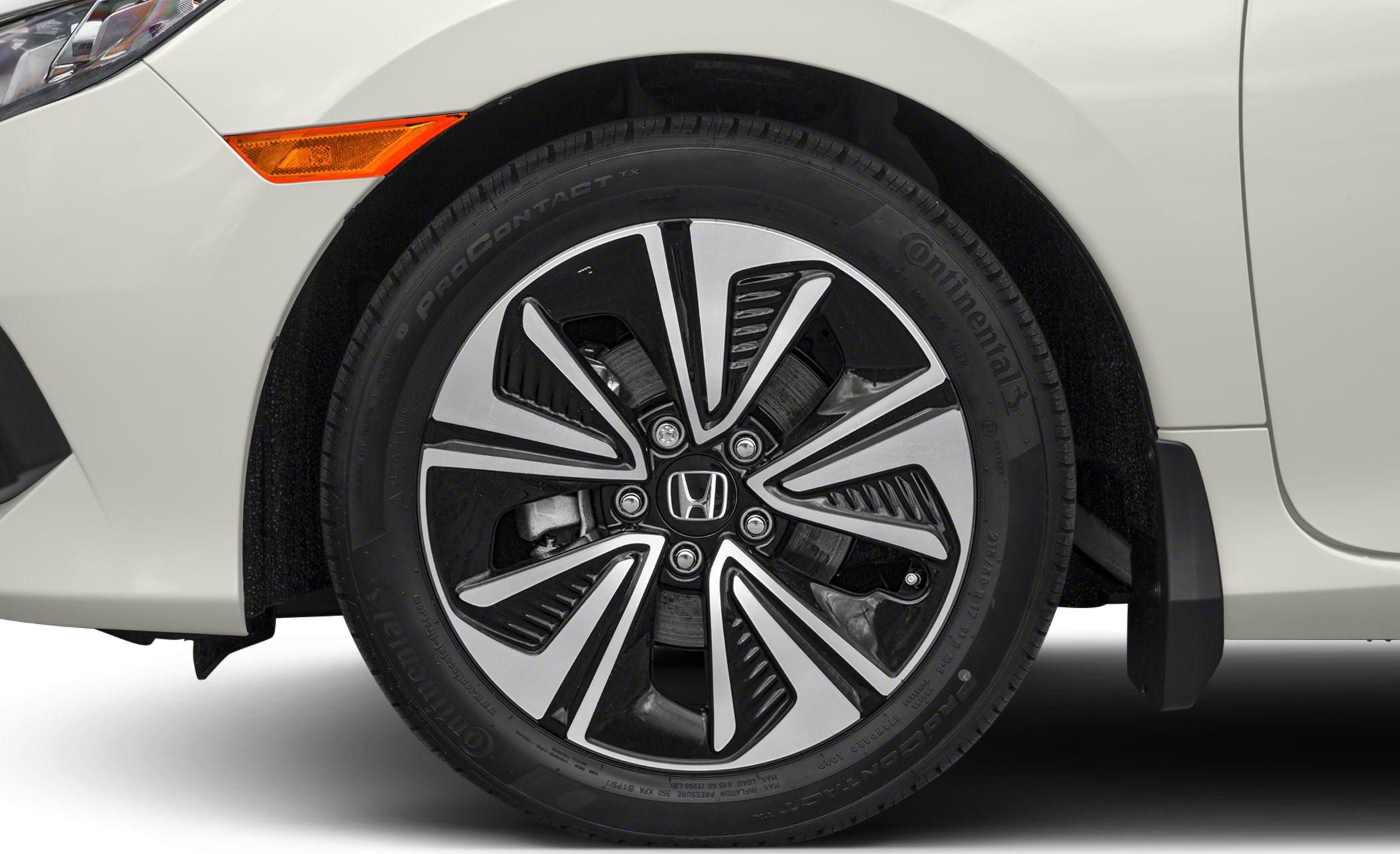 Close-up of alloy wheel and tire on a white car