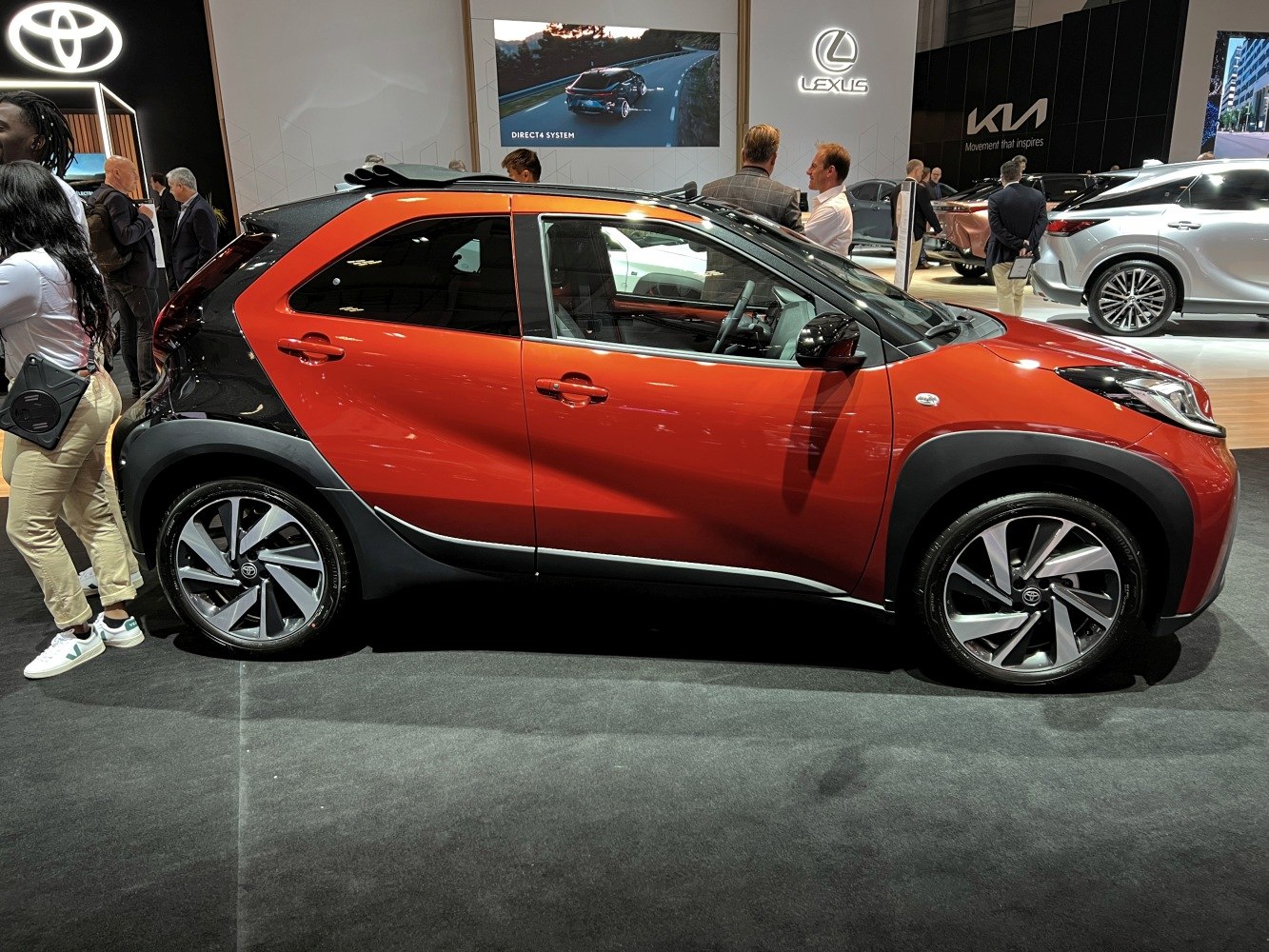 Side view of compact crossover with two-tone paint and alloy wheels.
