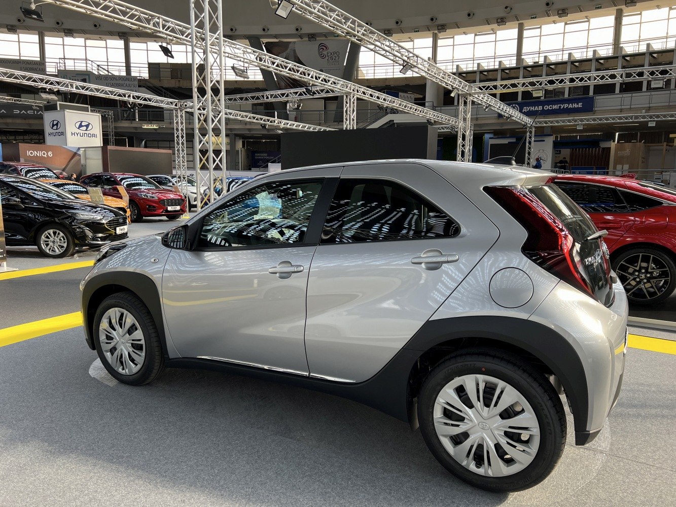 Side profile of a compact crossover hatchback with distinctive rear lights and black wheel arches