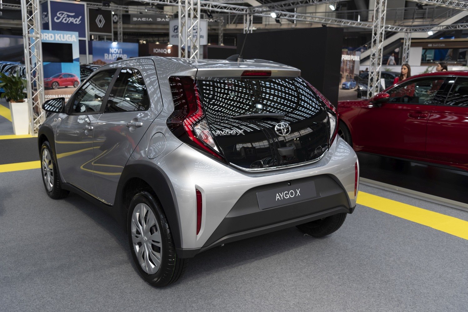 Compact hatchback rear with modern tail lights and reflective black panel