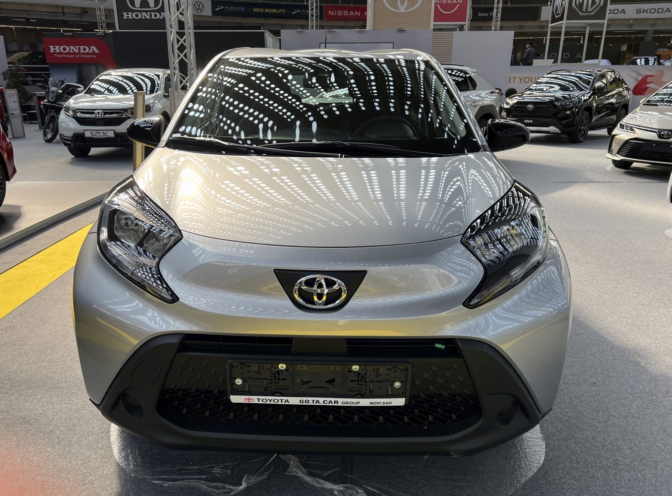 Distinctive front headlights and large grille of a compact hatchback